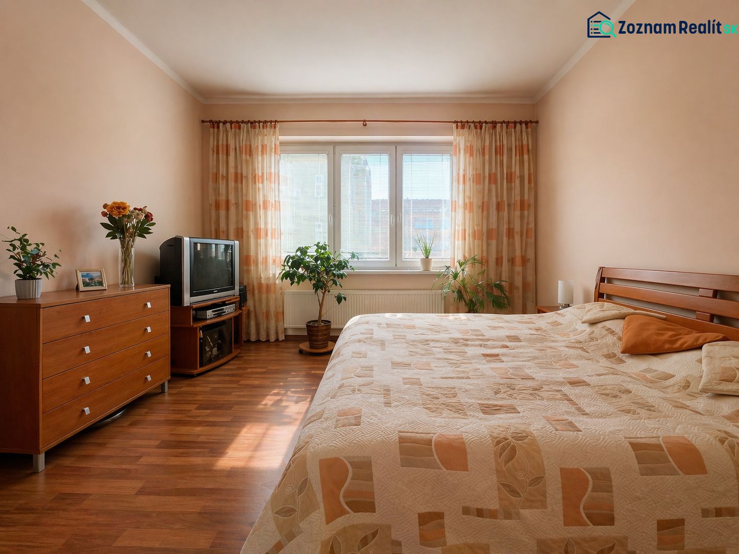 A bedroom in a 4-room apartment with a wood-patterned floor and soft lighting.