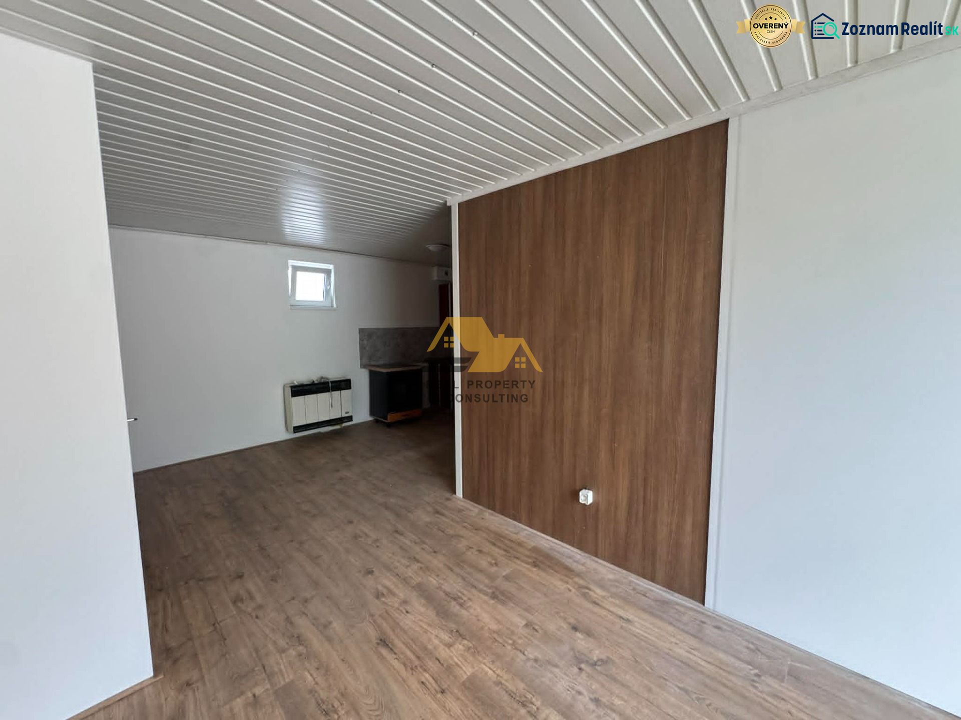 2-room apartment with wood-patterned flooring and white walls.