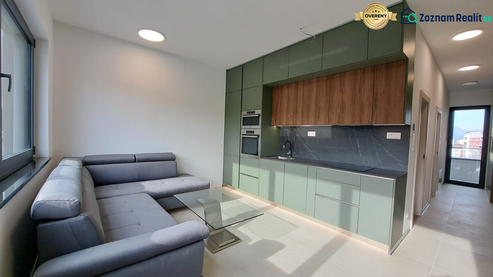 Stylish kitchen with a sofa and dining table in a 2-room apartment.