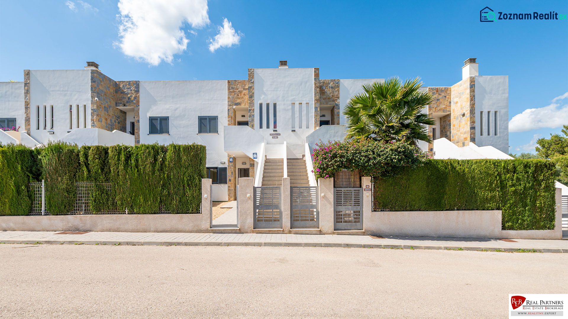 A recreational apartment in Cala Murada on Mallorca with a modern facade and a green fence.