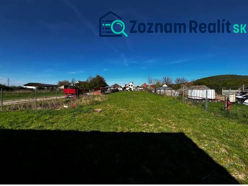 Lands - housing in Pernek, open green area, with fencing and a rural scene in the background.