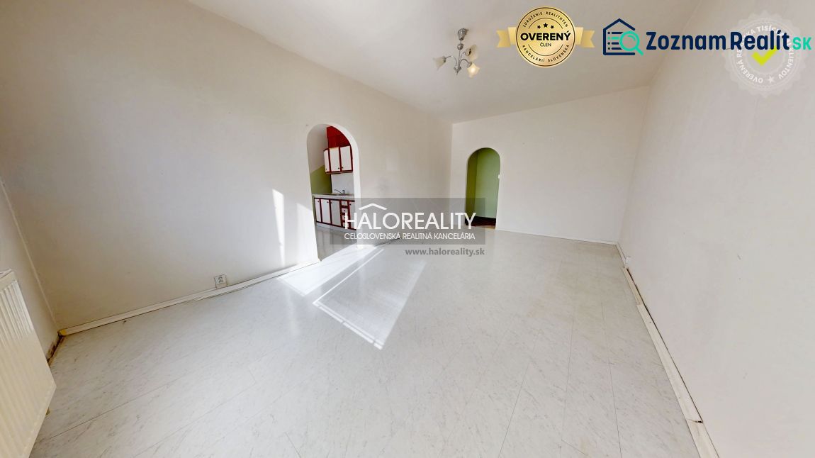 A spacious room in a 3-room apartment with a white floor and arched doorways.