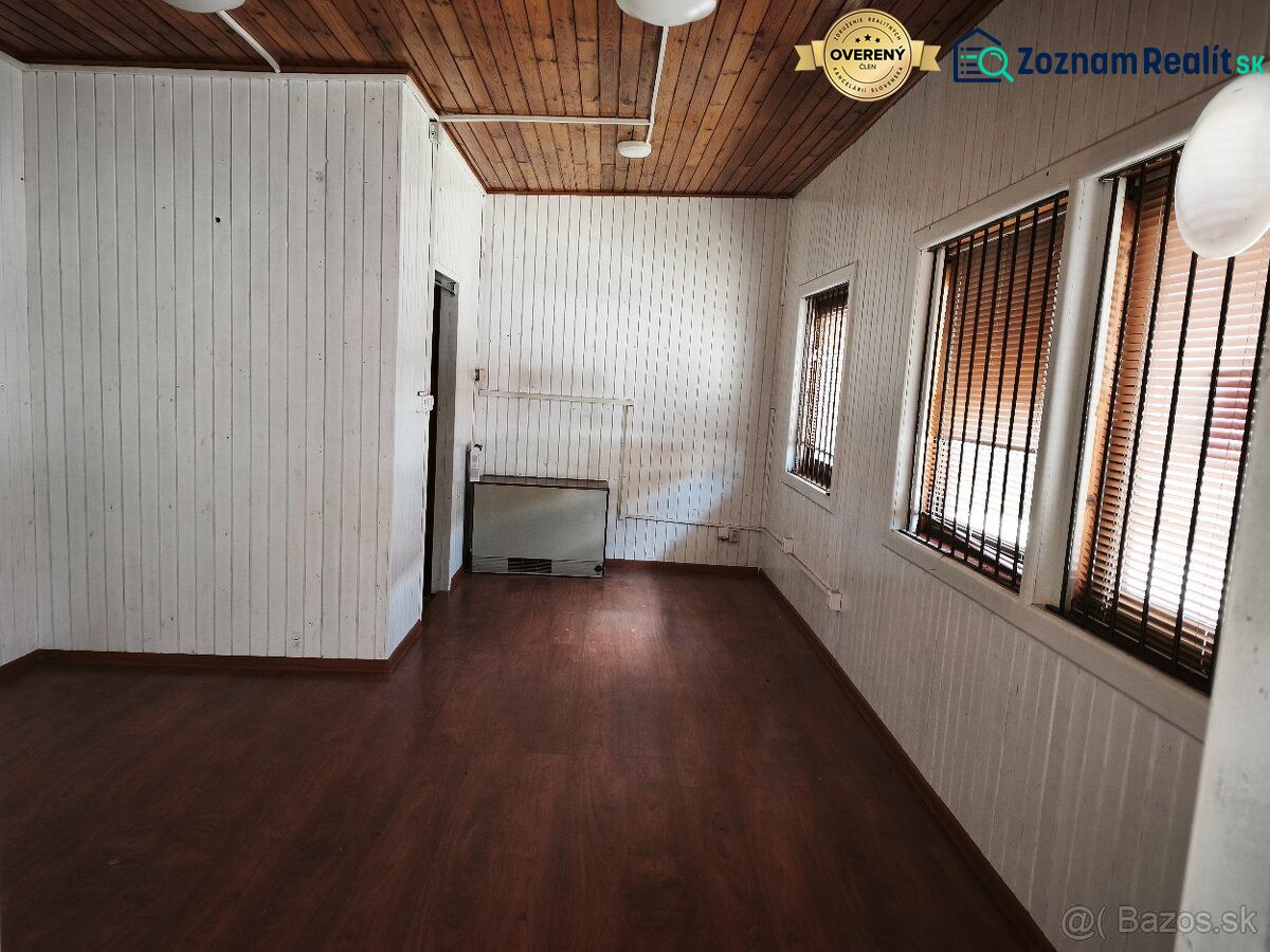 Commercial premises with a wood-patterned floor and walls with slat paneling.