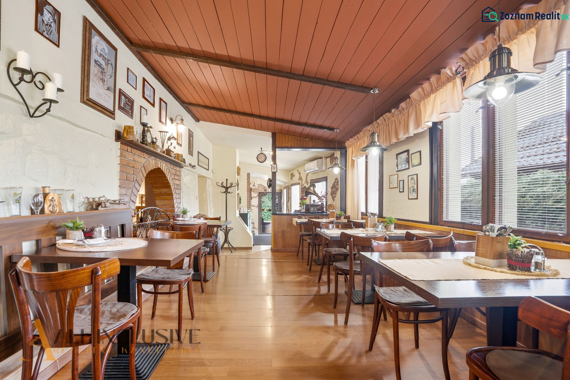 Gastro premises with wooden decor flooring, tables, and wall decorations.