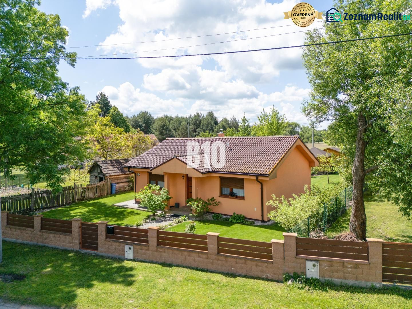 A family house in Bílkove Humence with a landscaped garden and terracotta facade.