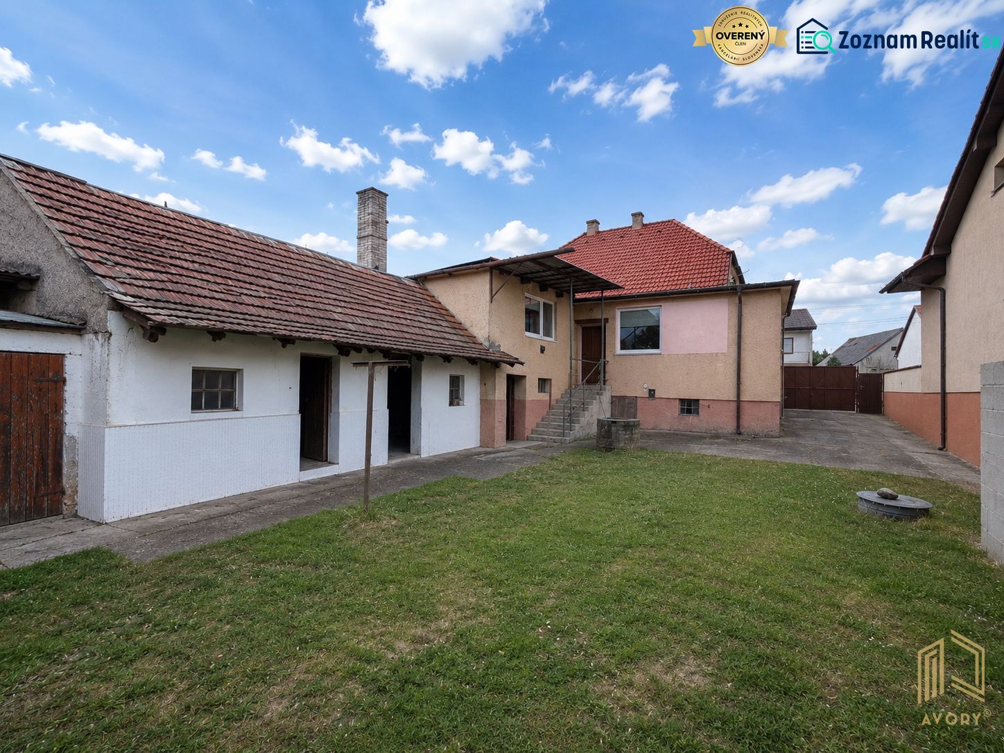 A family house in Rovensko with a spacious yard, lawn, and an adjacent building.