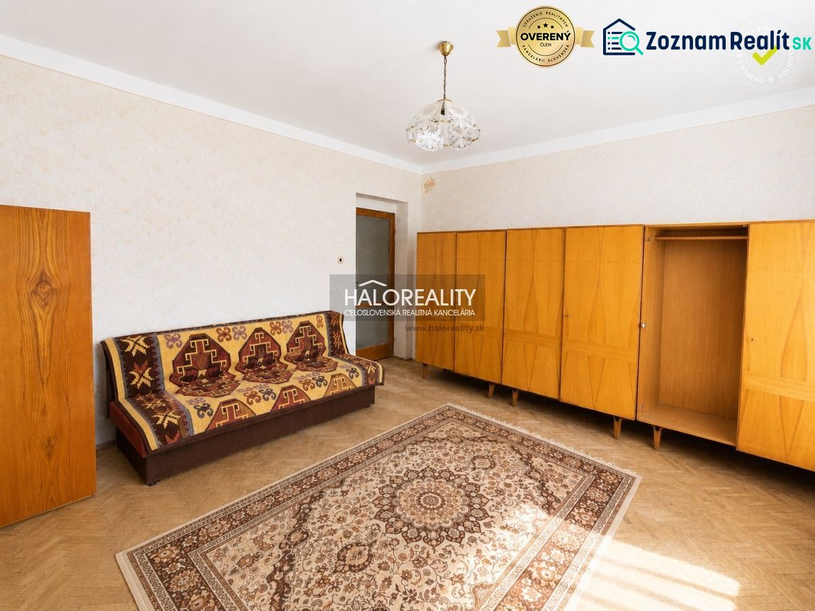 Living room with carpet and furniture, wooden decor flooring in a family house.