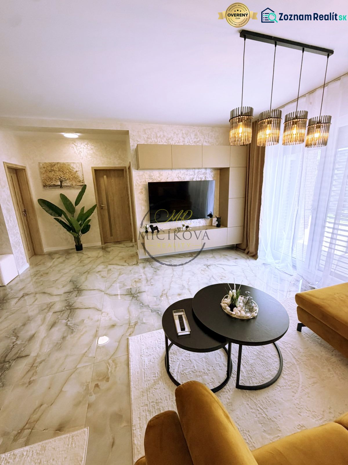 Living room in a two-room apartment with marble flooring and stylish lighting.