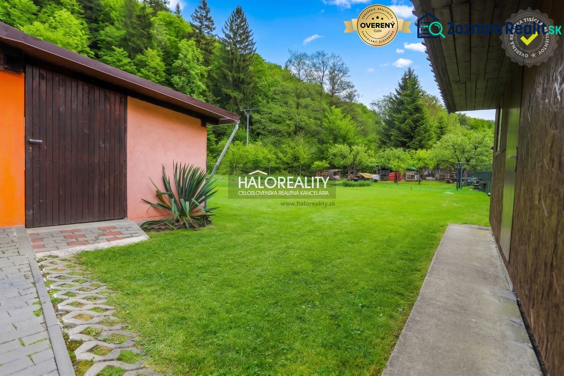 A family house in Dolná Mariková surrounded by a garden with a lawn and storage space.