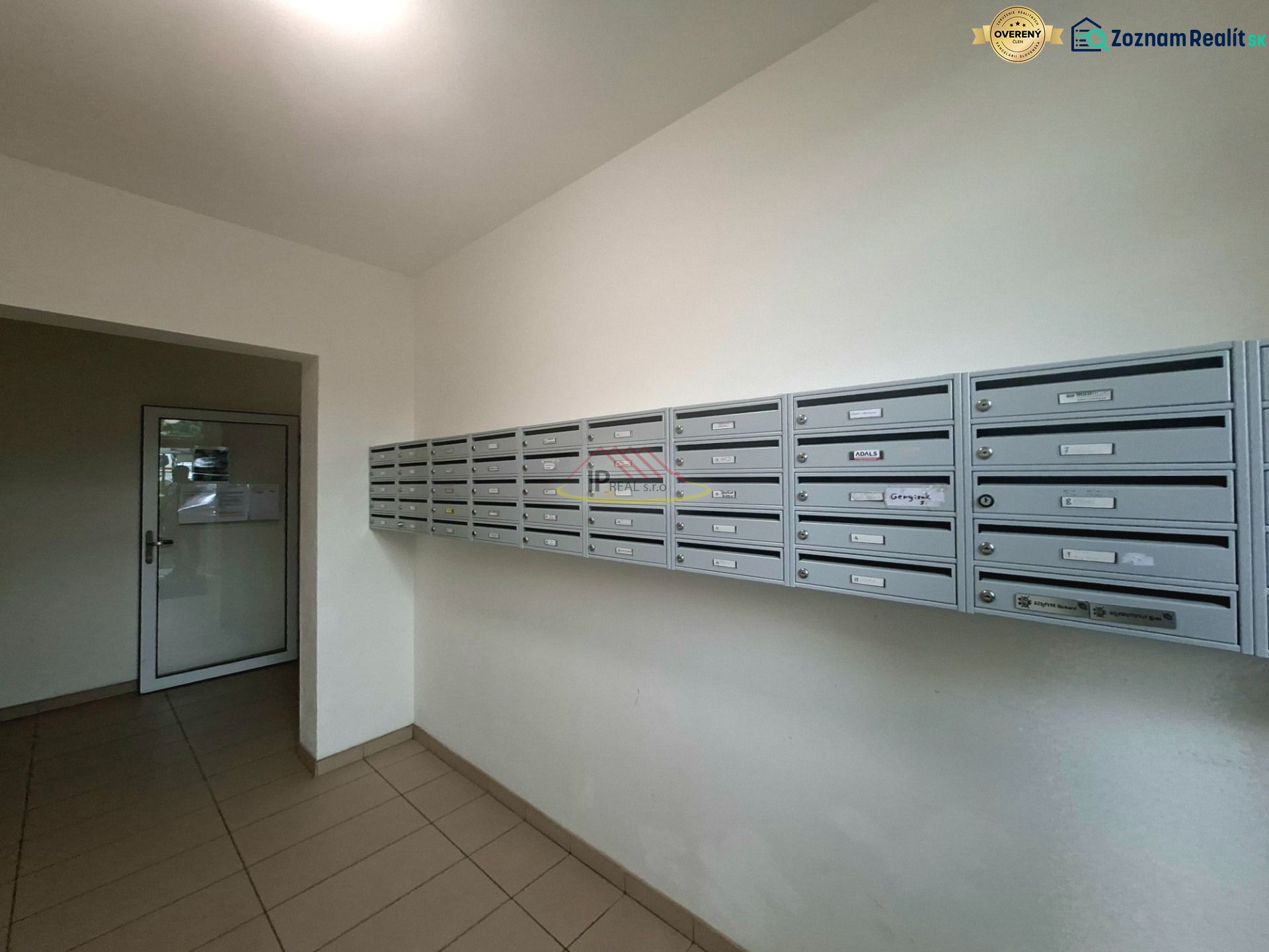 Mailboxes in the entrance hall of the studio apartment, tiled floor, simple design.