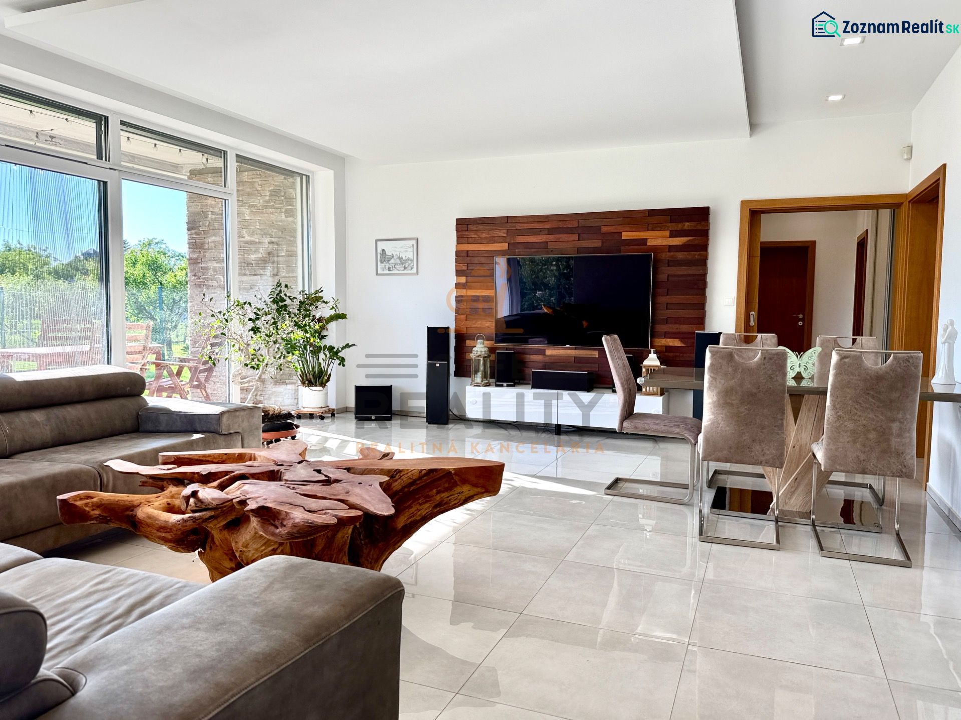 Living room in a family house with a leather sofa, unique wooden table, and television.