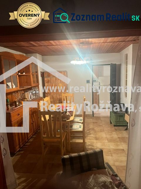 Dining area in a cabin with wooden furniture and lighting.