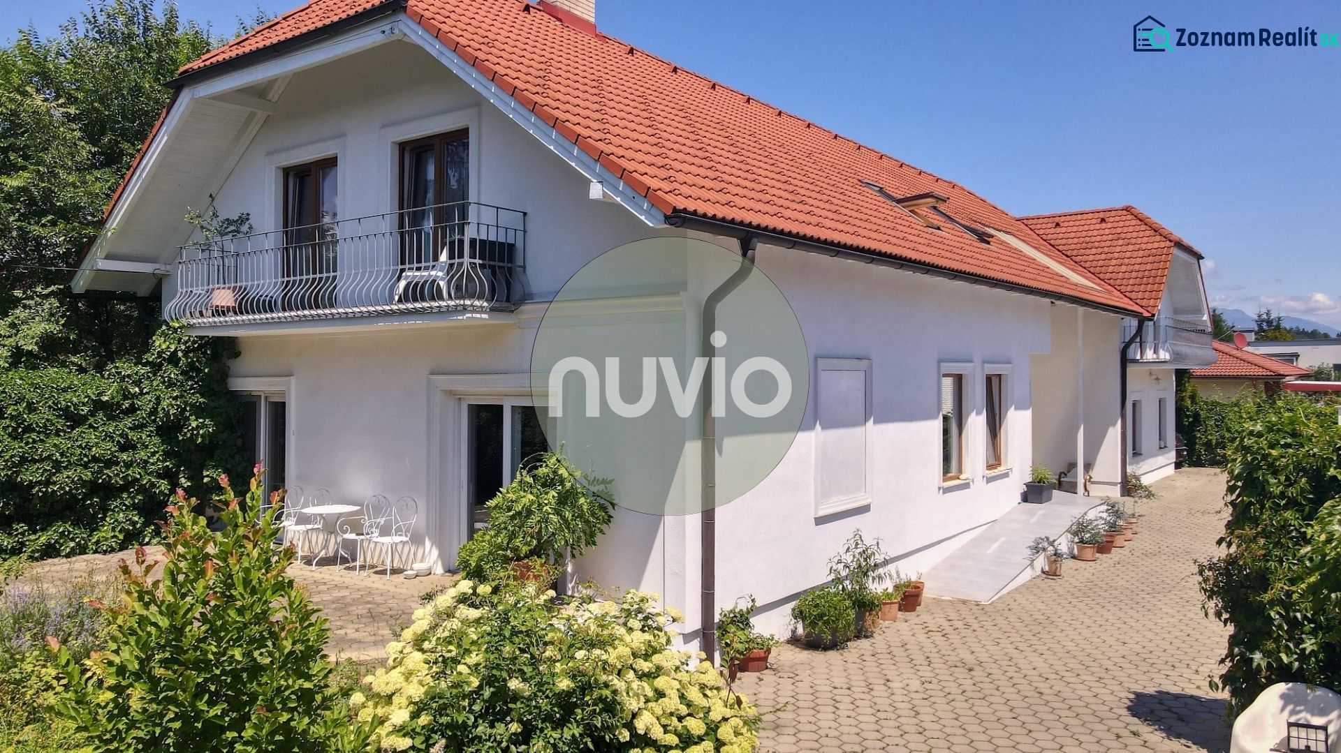 A family house in Žabokreky on Žabokreky Street with a white facade and a red roof.