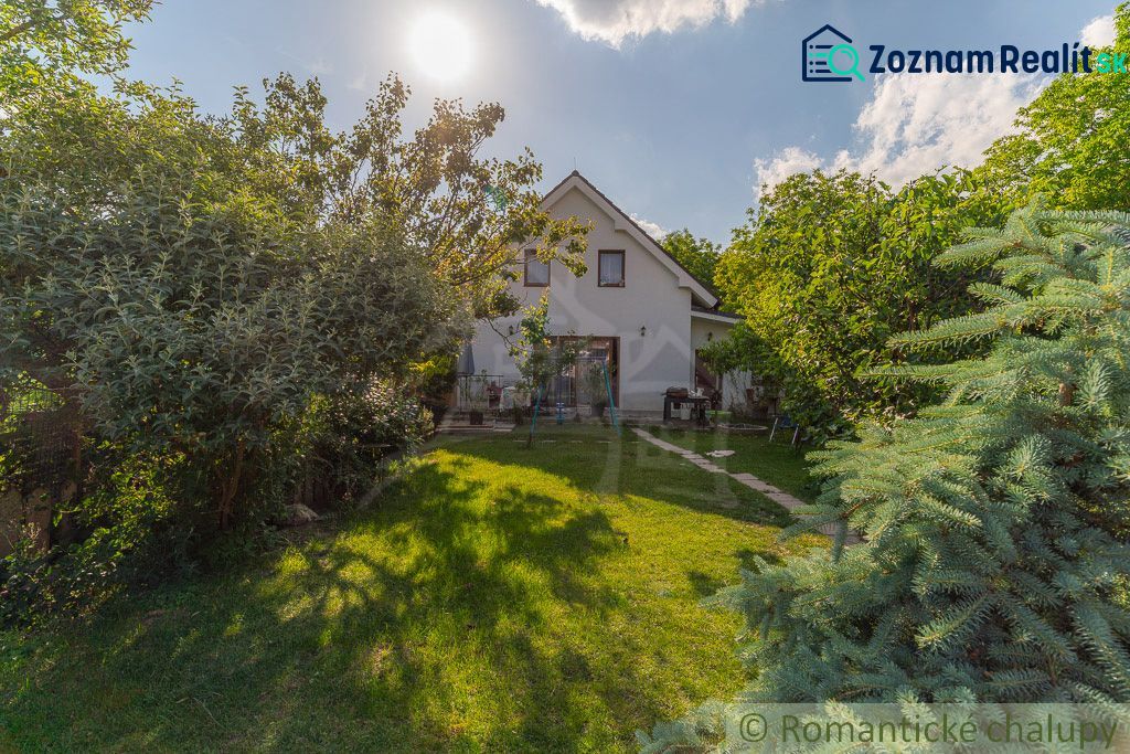 A family house in Bernolákovo surrounded by a lush garden on a sunny plot.