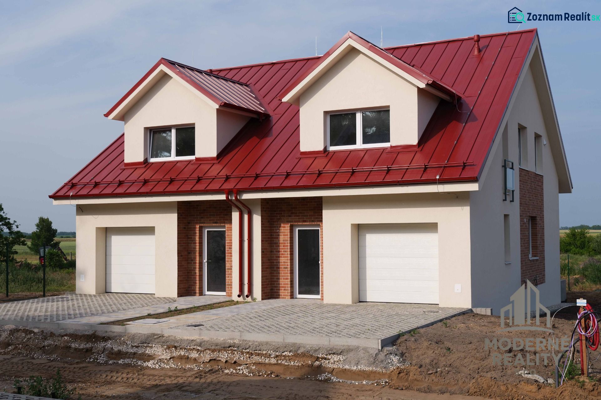 A family house in Andovce with a red roof and a double garage in a peaceful location.