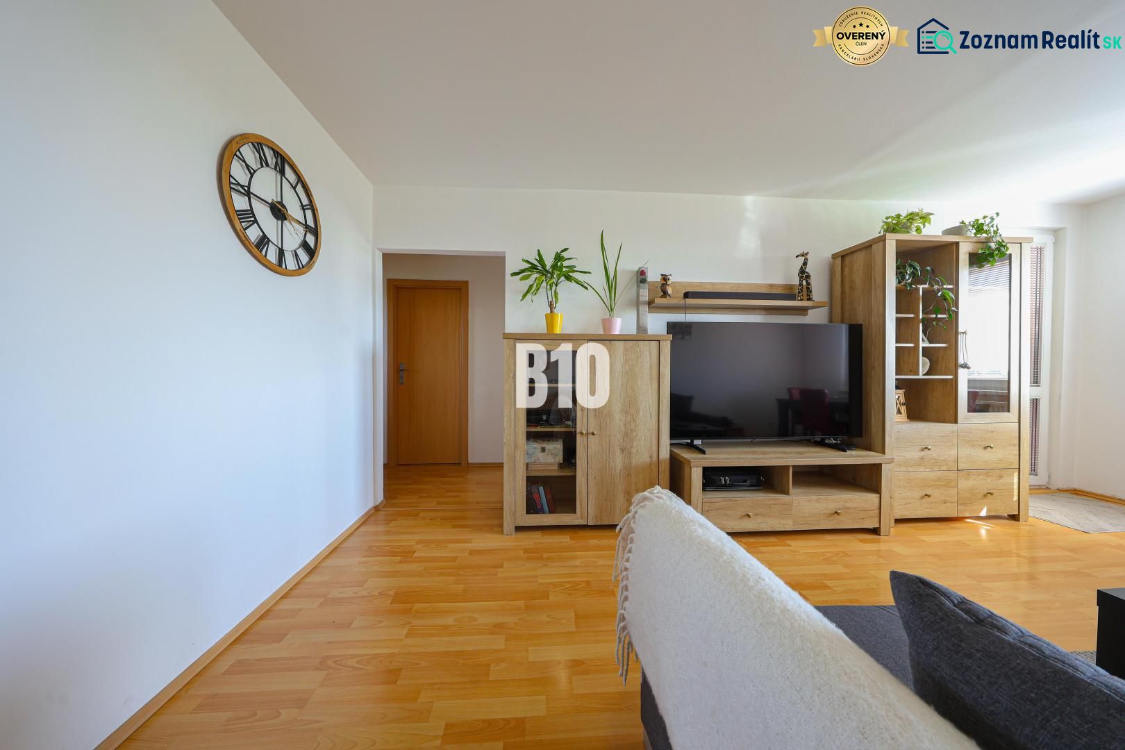 Living room in a 3-room apartment with a wooden decor floor and furniture.