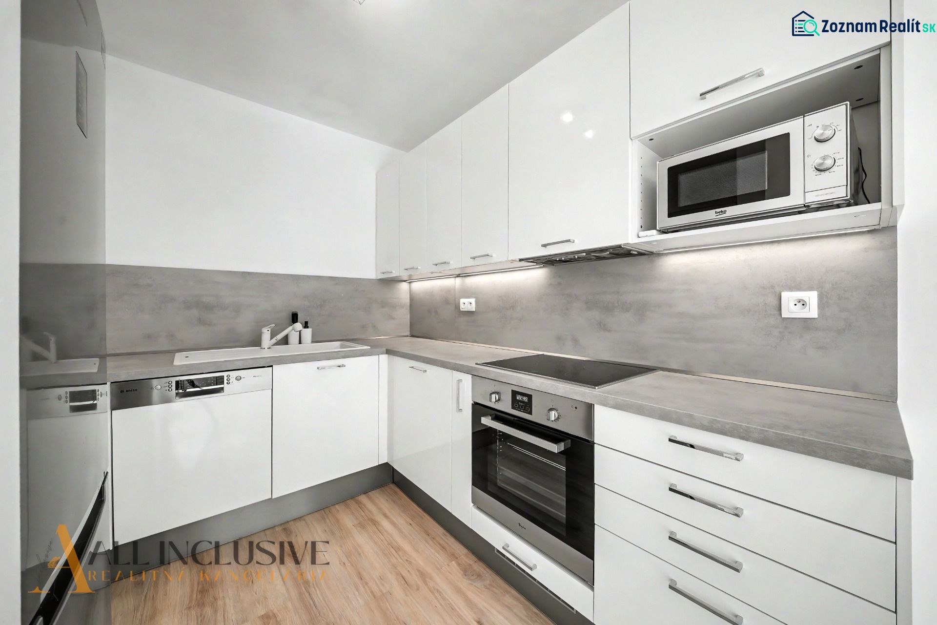 A kitchen with a corner unit and a wooden decor floor in a 2-room apartment.