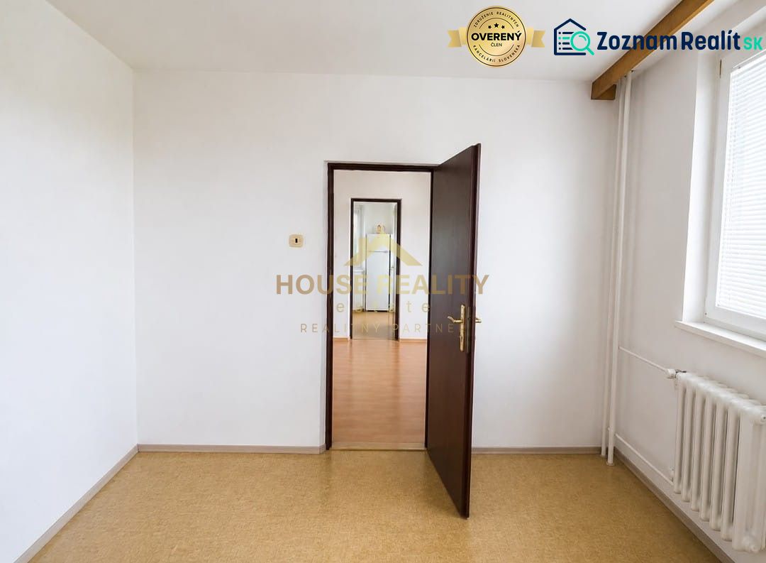 A white interior in a 3-room apartment with doors and a window.