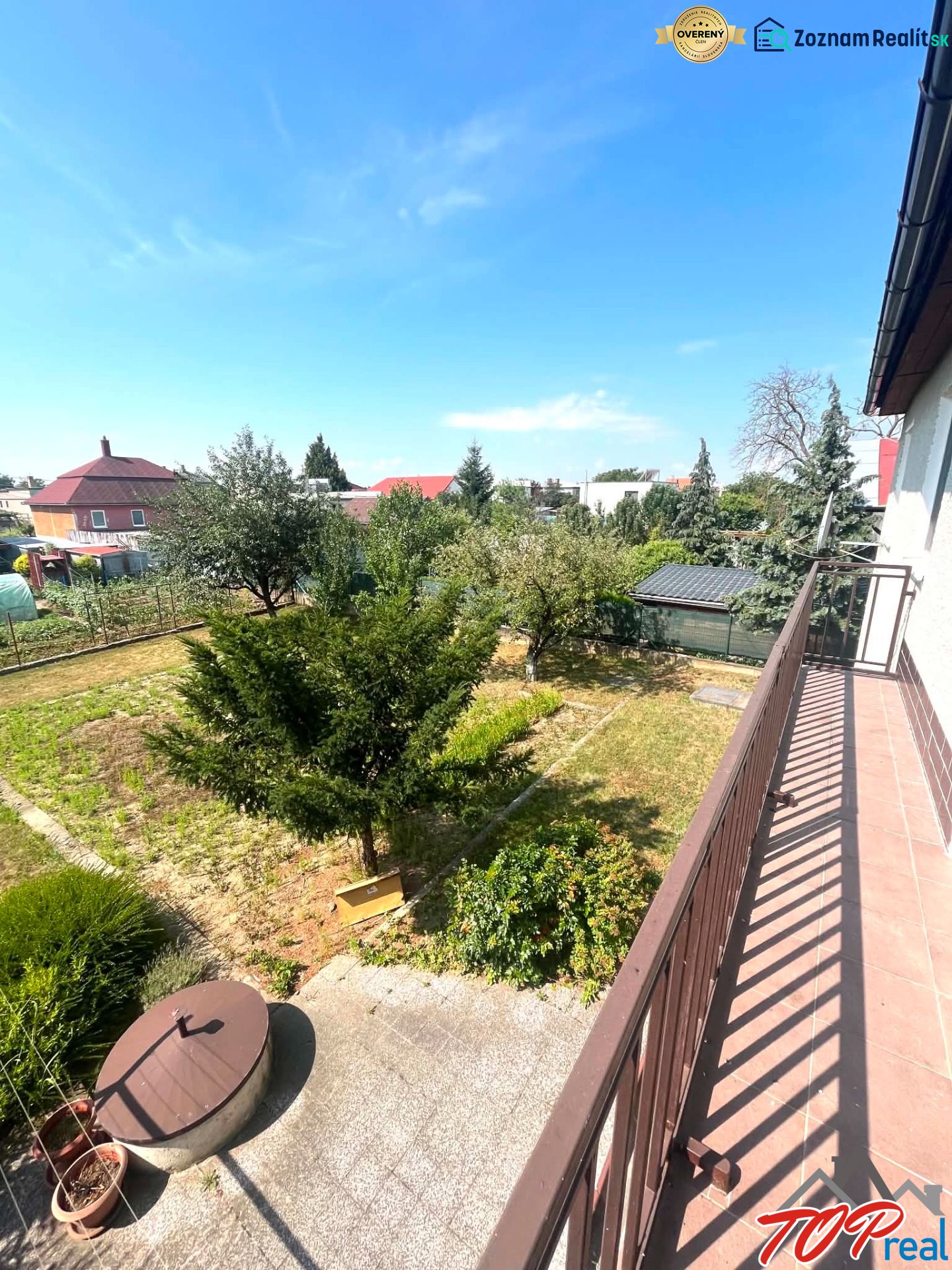 From the balcony of the family house on Agátová Street in Čaňa, you can see a green garden.