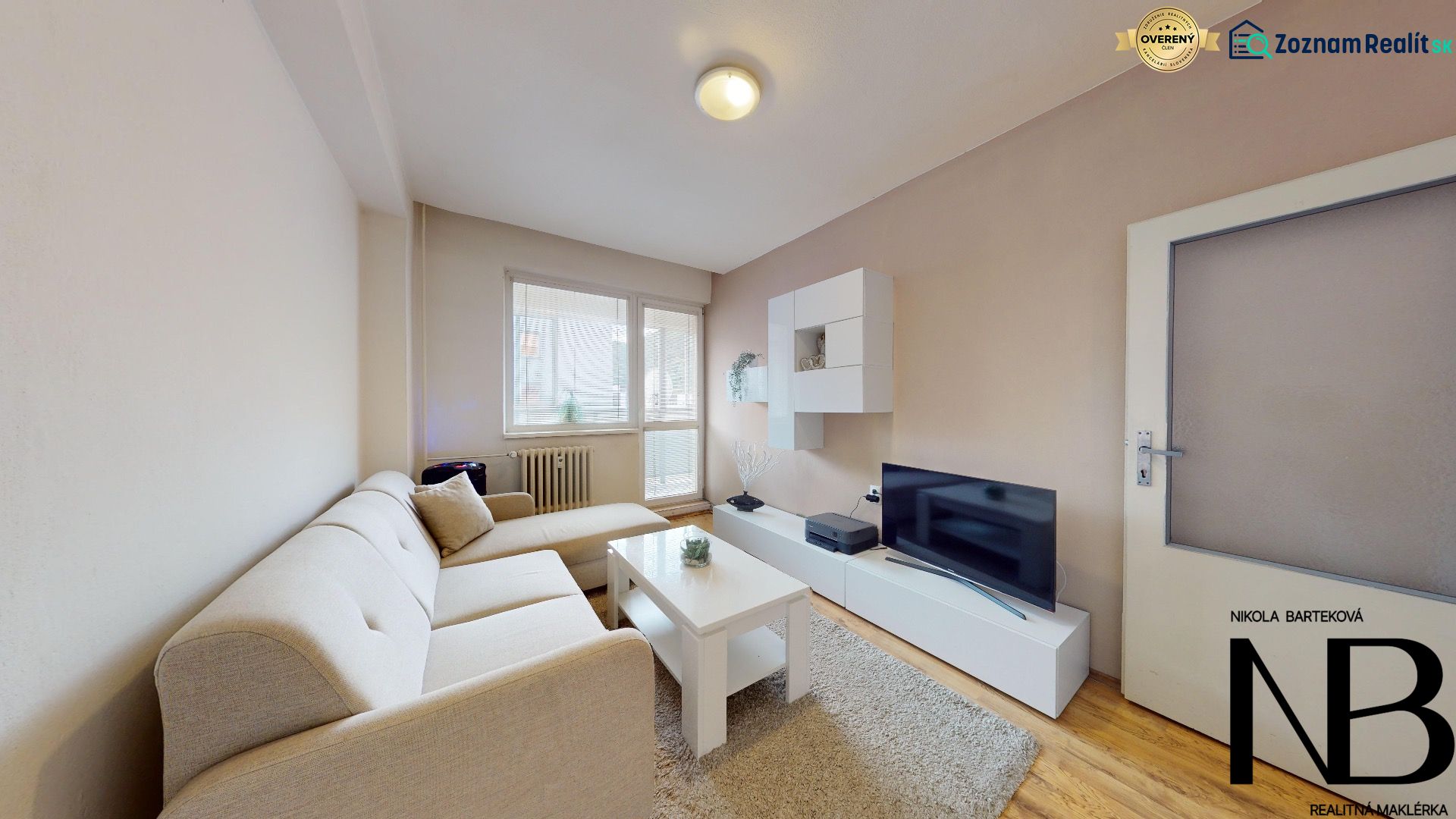 Living room of a two-room apartment on K výstavisku street with a comfortable sofa and a television.