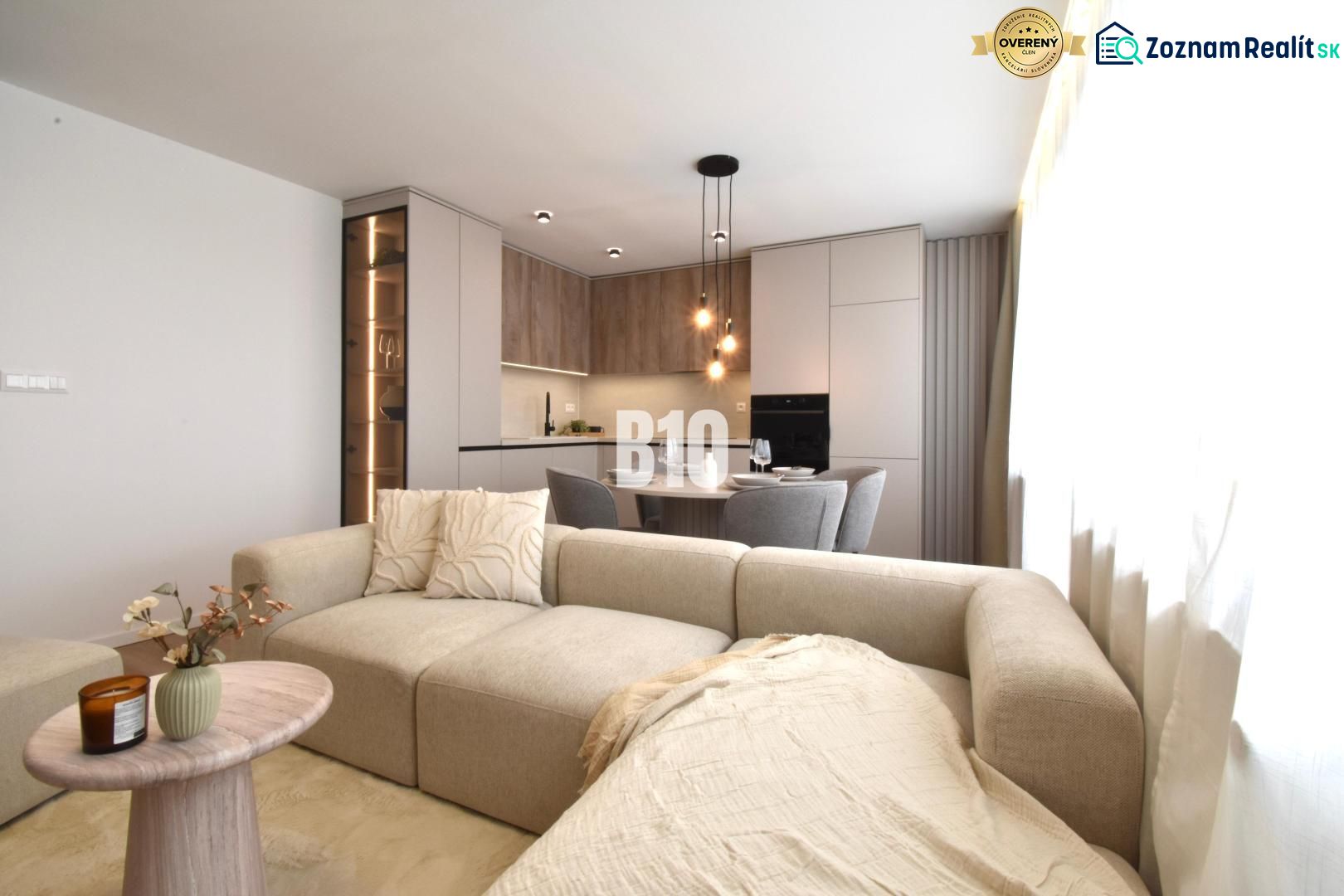 Living room with kitchen in a 4-room apartment with a wooden decor floor.