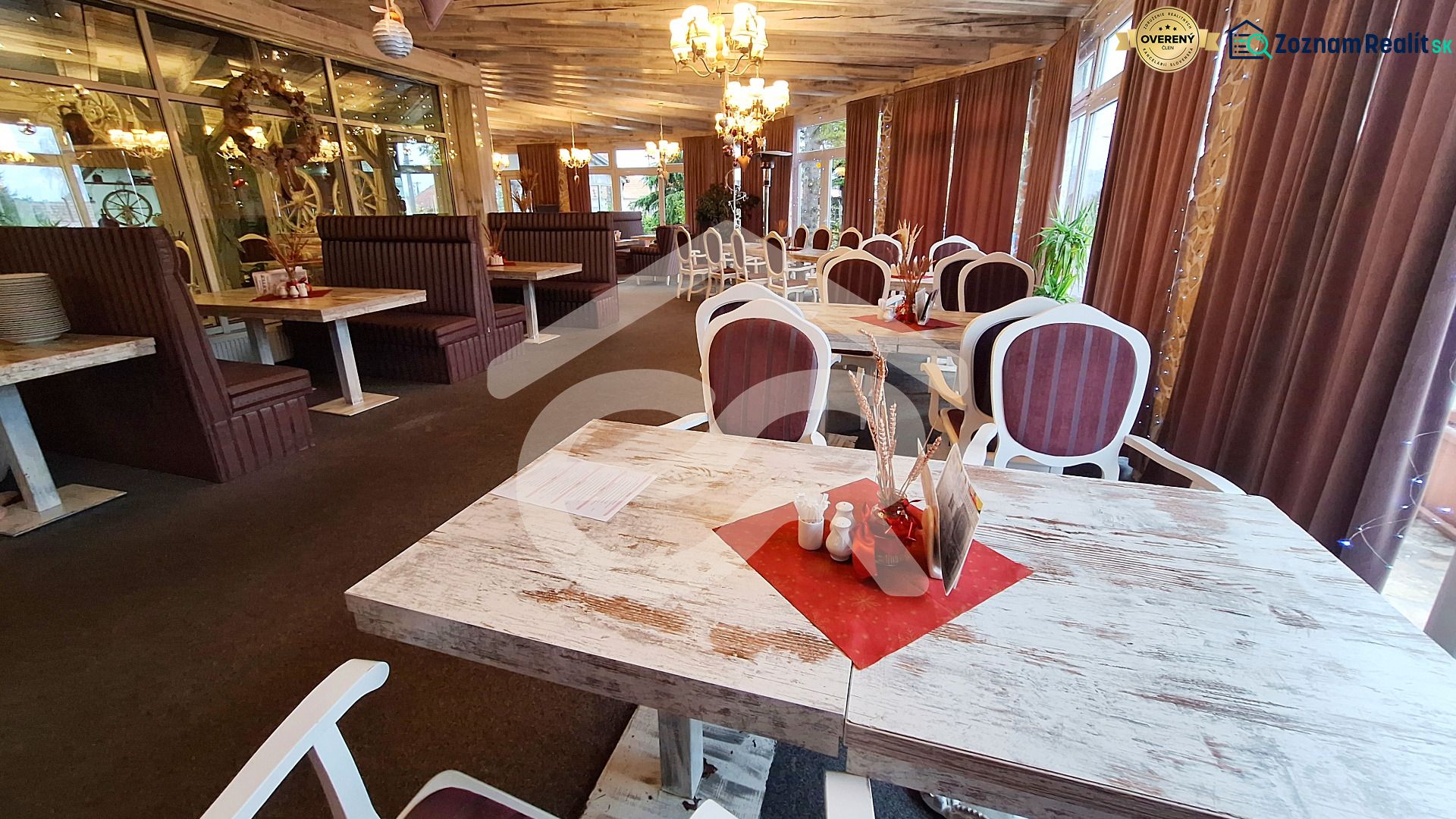 A restaurant with wooden tables, comfortable seating, and decorative lighting in hotels and guesthouses.