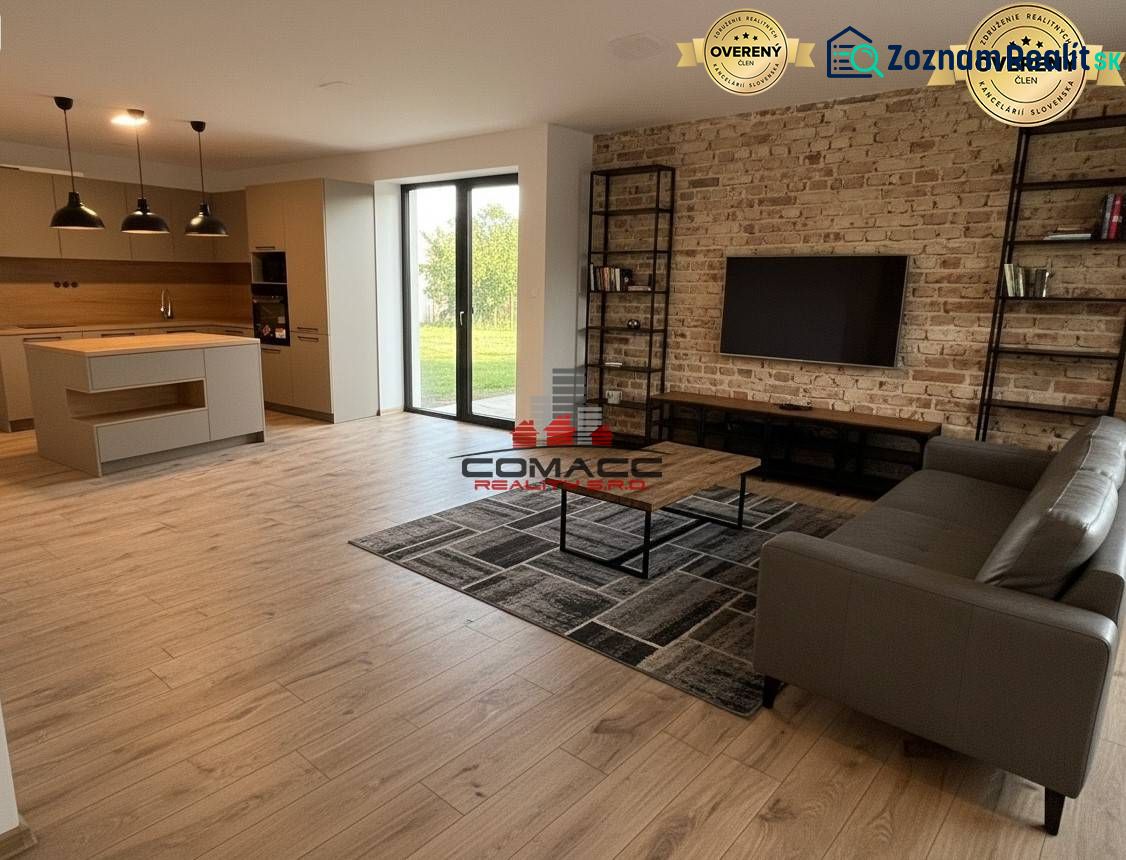 A bright living room in a family house with a wood-patterned floor and a brick wall.