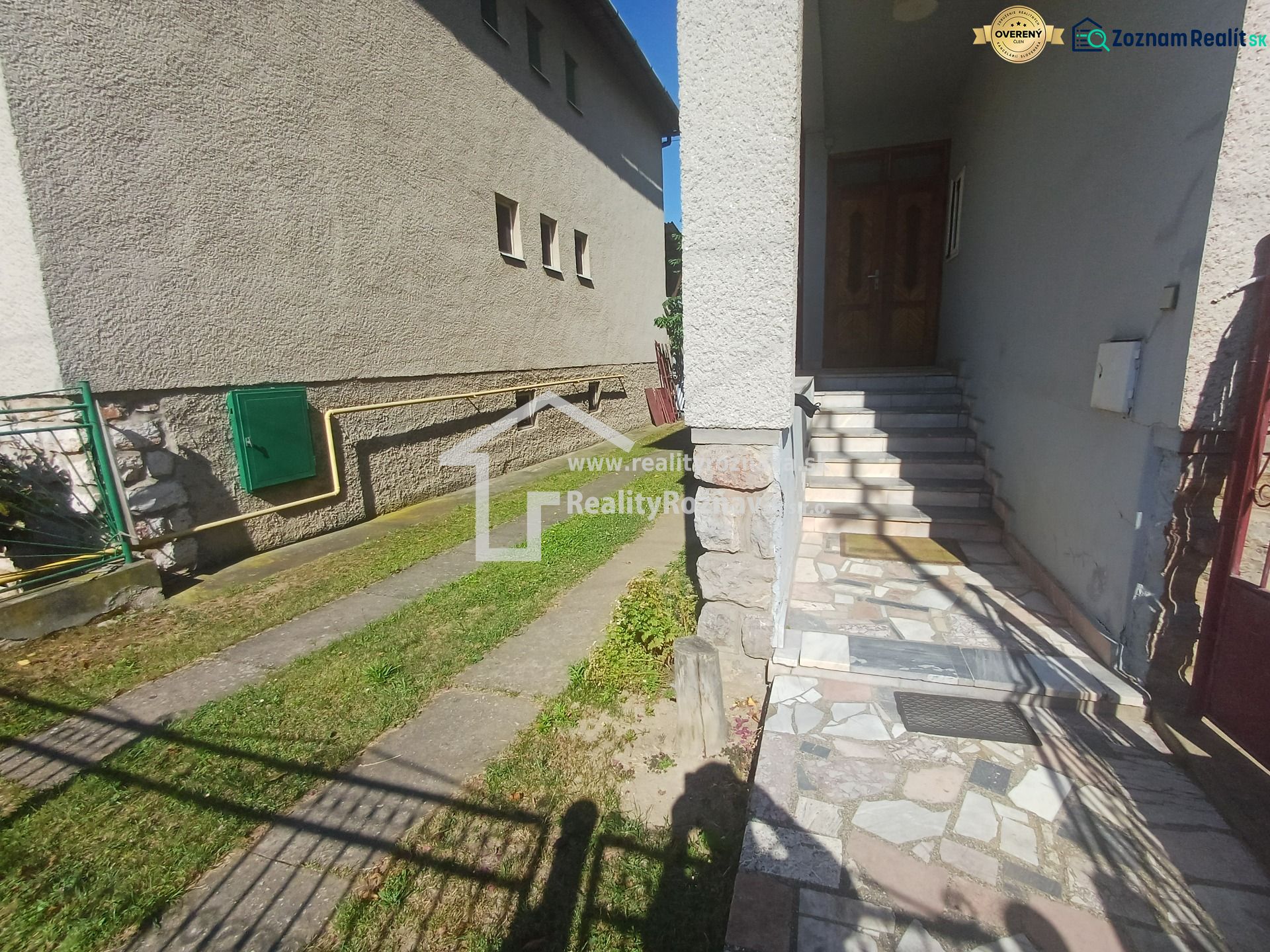 Entrance to a family house in Rožňava with stairs and a paved terrace.