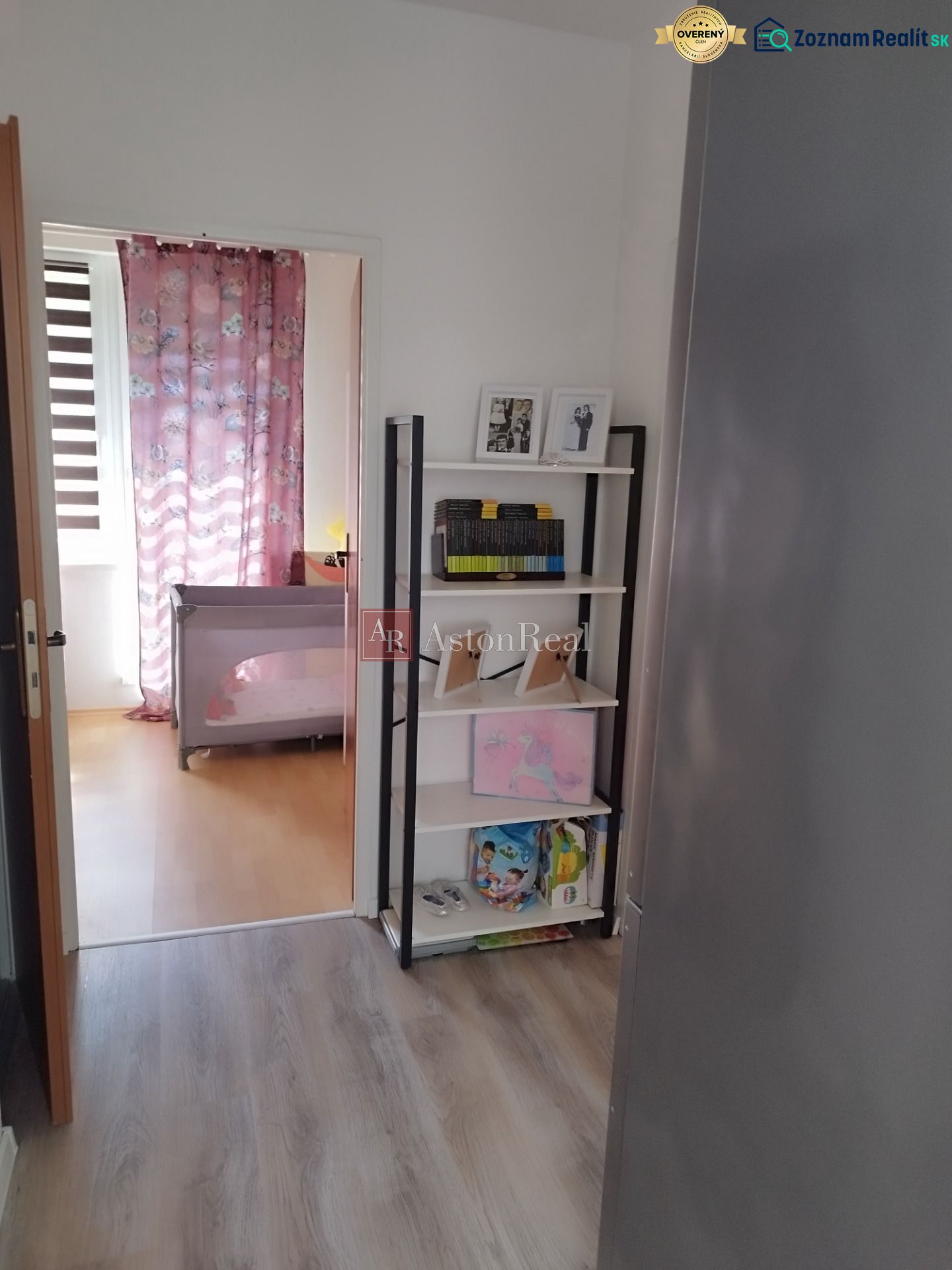 Interior of a 2-room apartment with a shelf and a wooden decor floor.