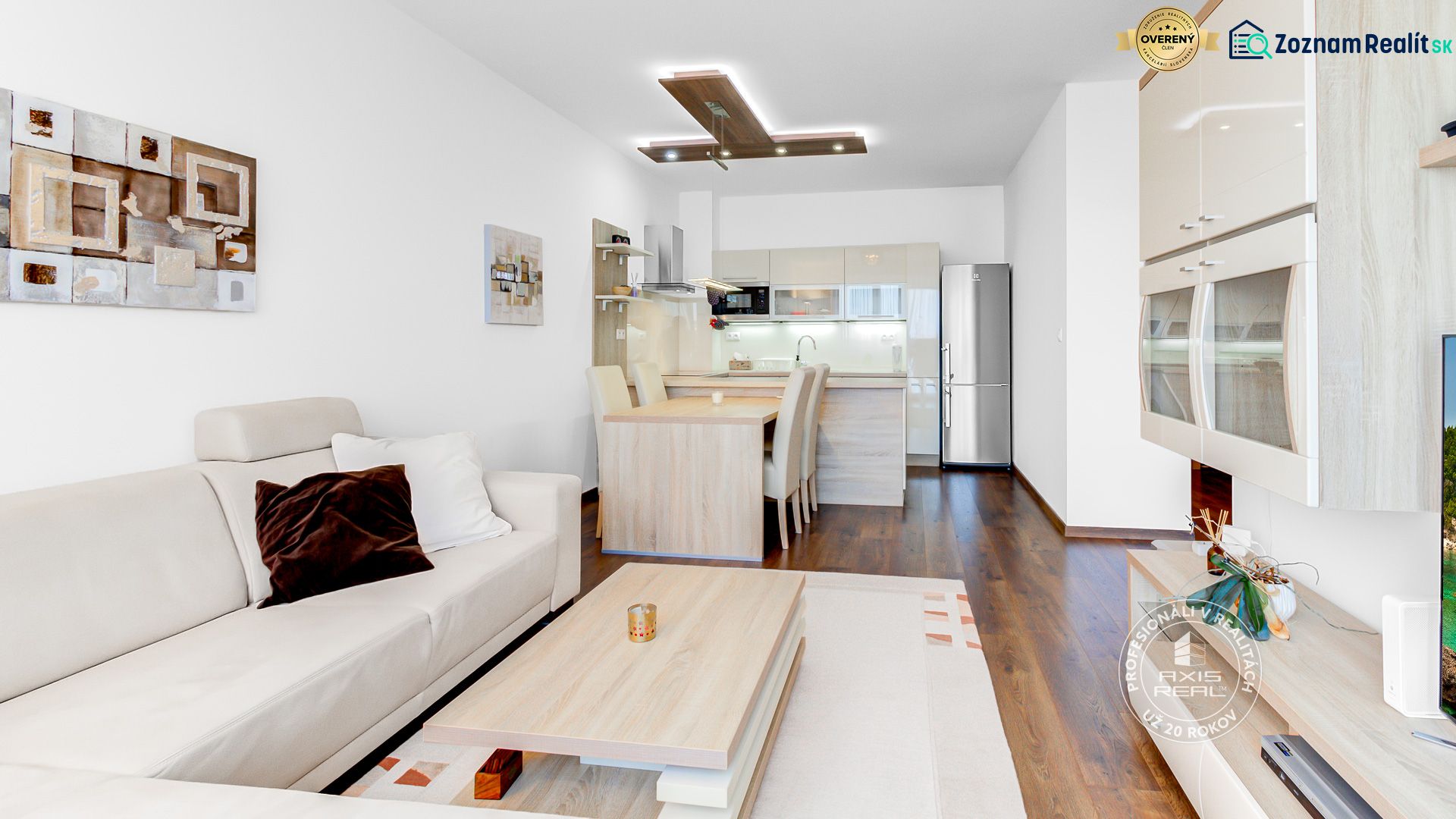 Living area of a 2-room apartment with a wooden decor floor and comfortable seating.