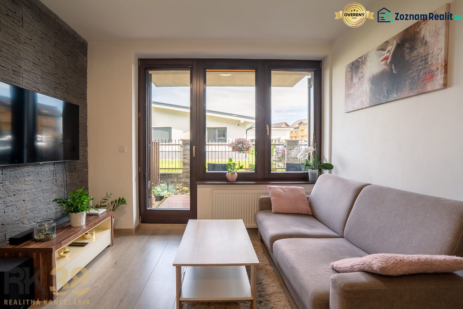 Living room in a 2-room apartment with a wood-patterned floor and a view outside.