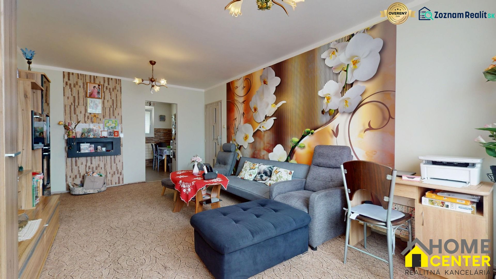 Living room in a 3-room apartment with floral wallpaper and comfortable seating.