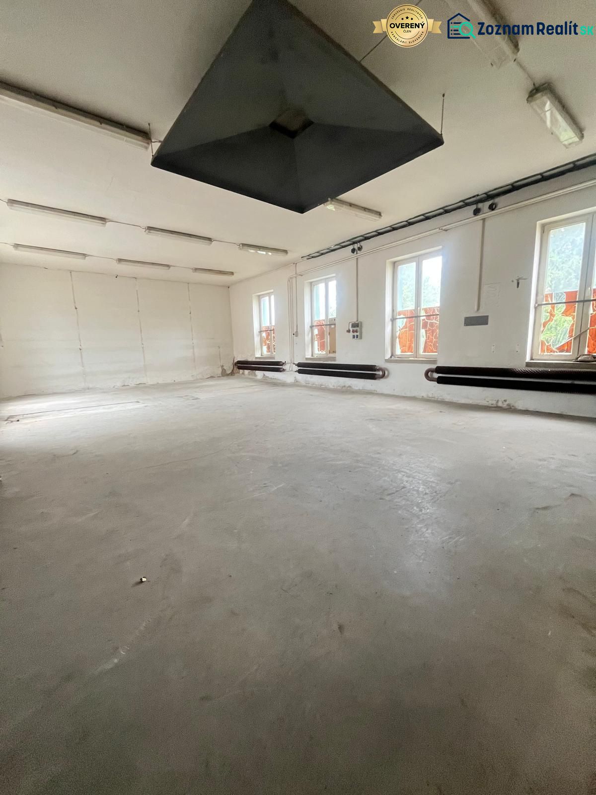 Production spaces with a minimalist interior, white walls, and gray floor.