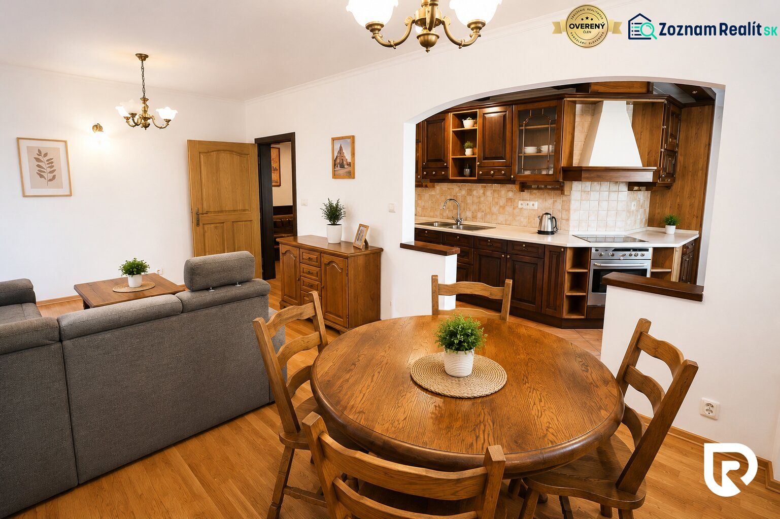 Living room with a kitchen and wooden decor in a 2-room apartment, with a dining table.