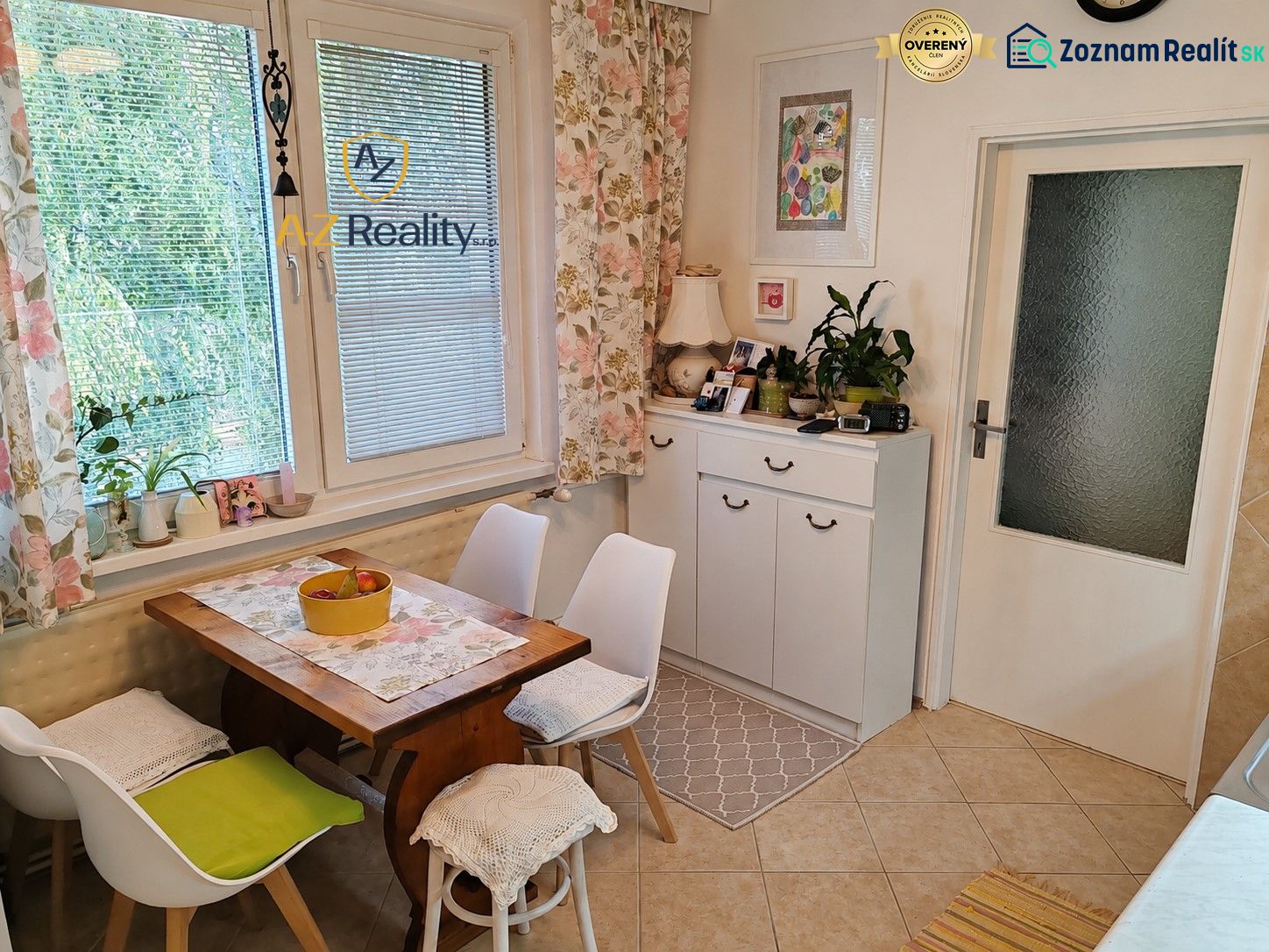 Dining area with a table and chairs, decorative curtains, and houseplants in a 4-room apartment.