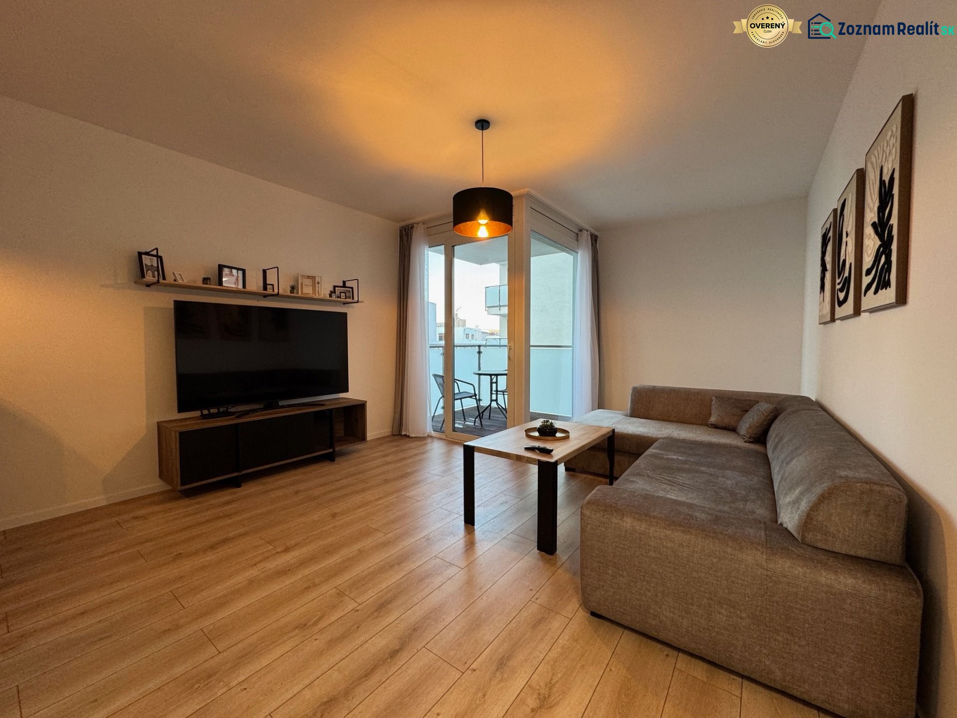 Living room in a two-room apartment with a sofa and a balcony, floor with wood decor.
