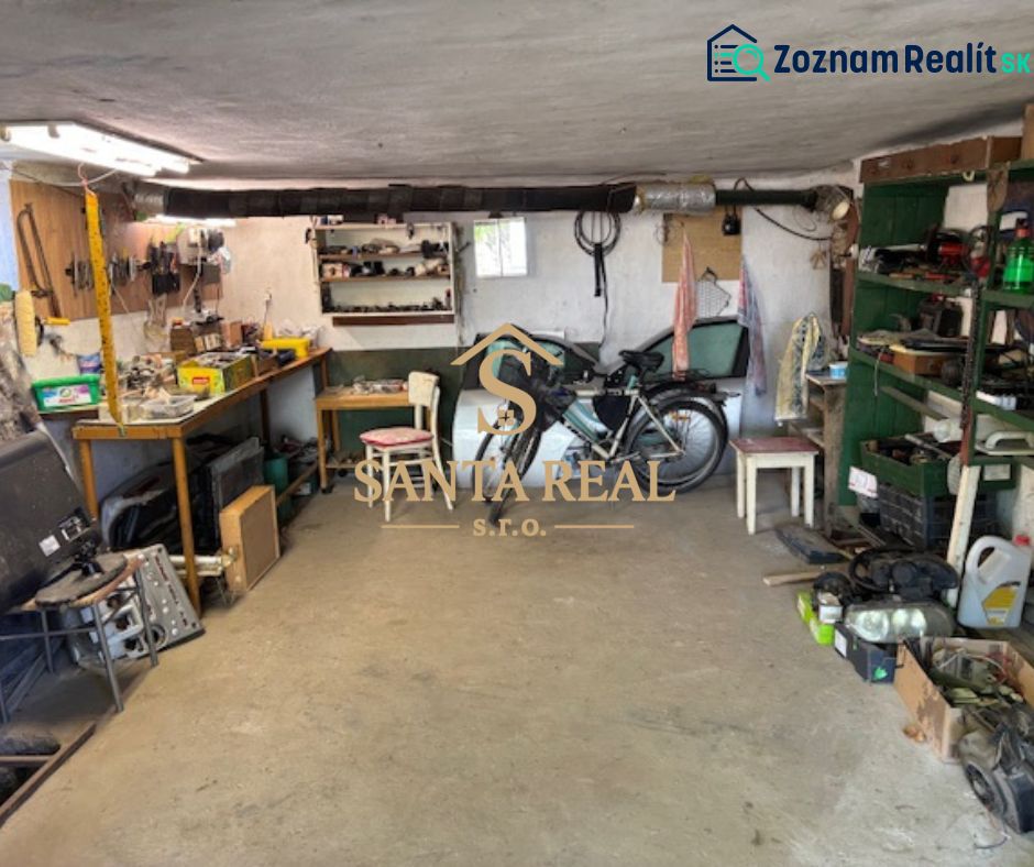 A garage with a workshop in a family house, equipped with workbenches and a bicycle.