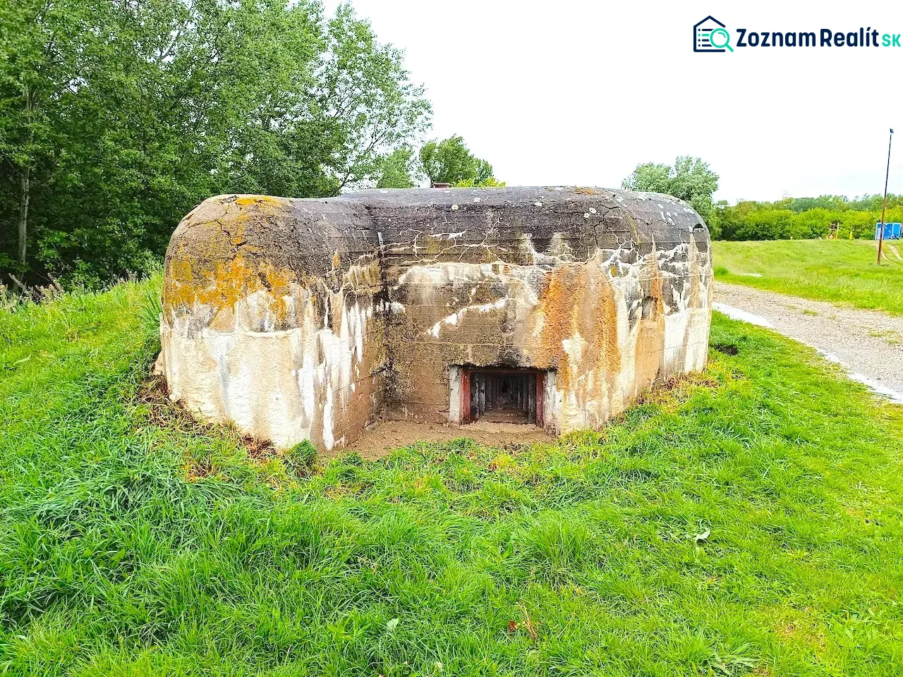 Unusual real estate in Malacky: An old military bunker surrounded by greenery in a natural environment.