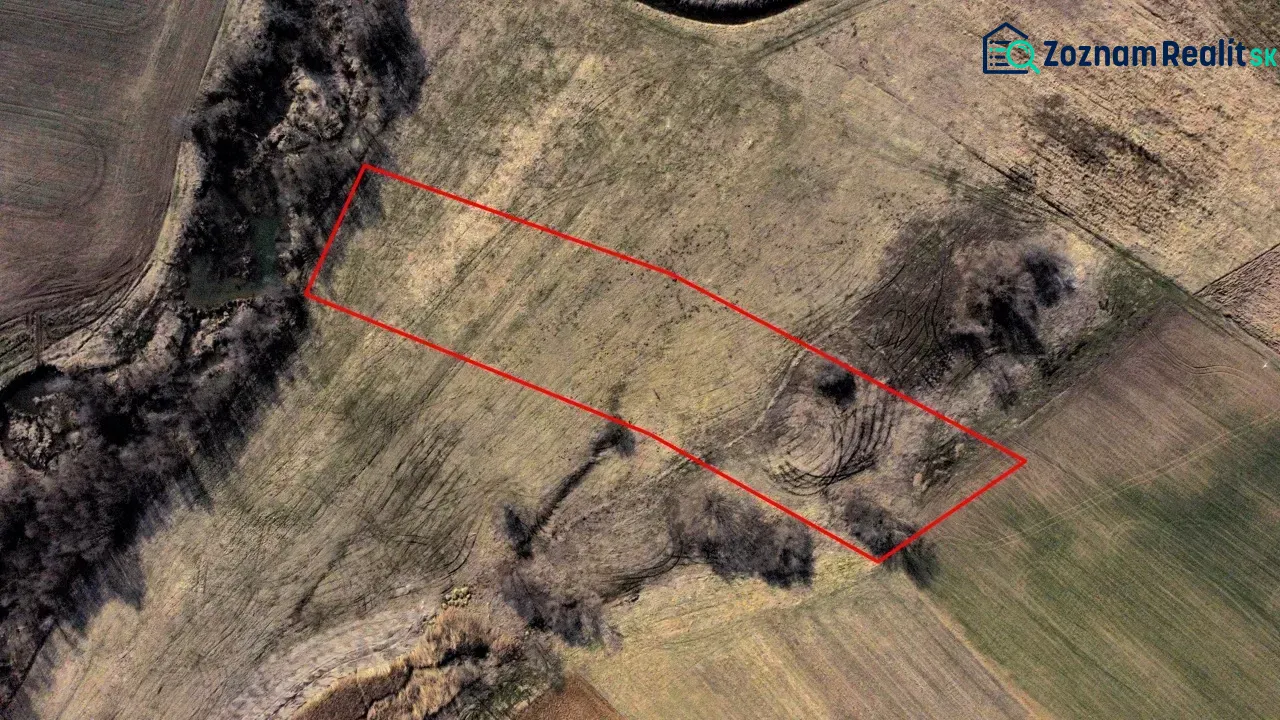 Aerial view of agricultural and forest land in Podhorany with a marked area.