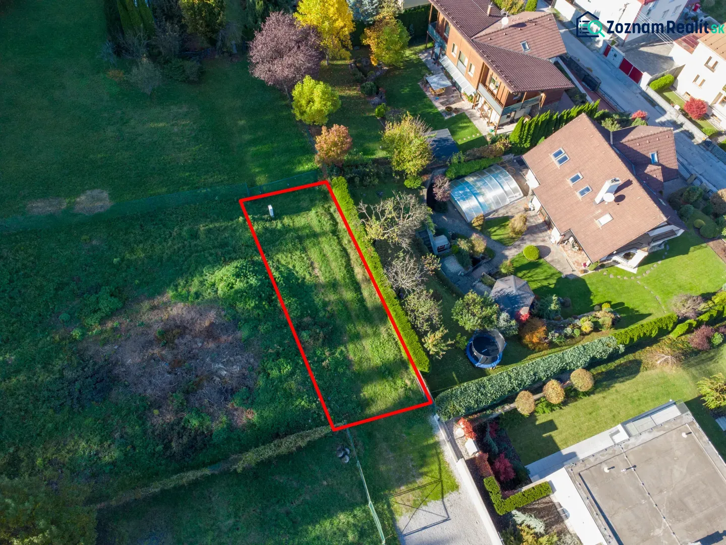 Aerial view of green gardens in Banská Bystrica with a highlighted plot.