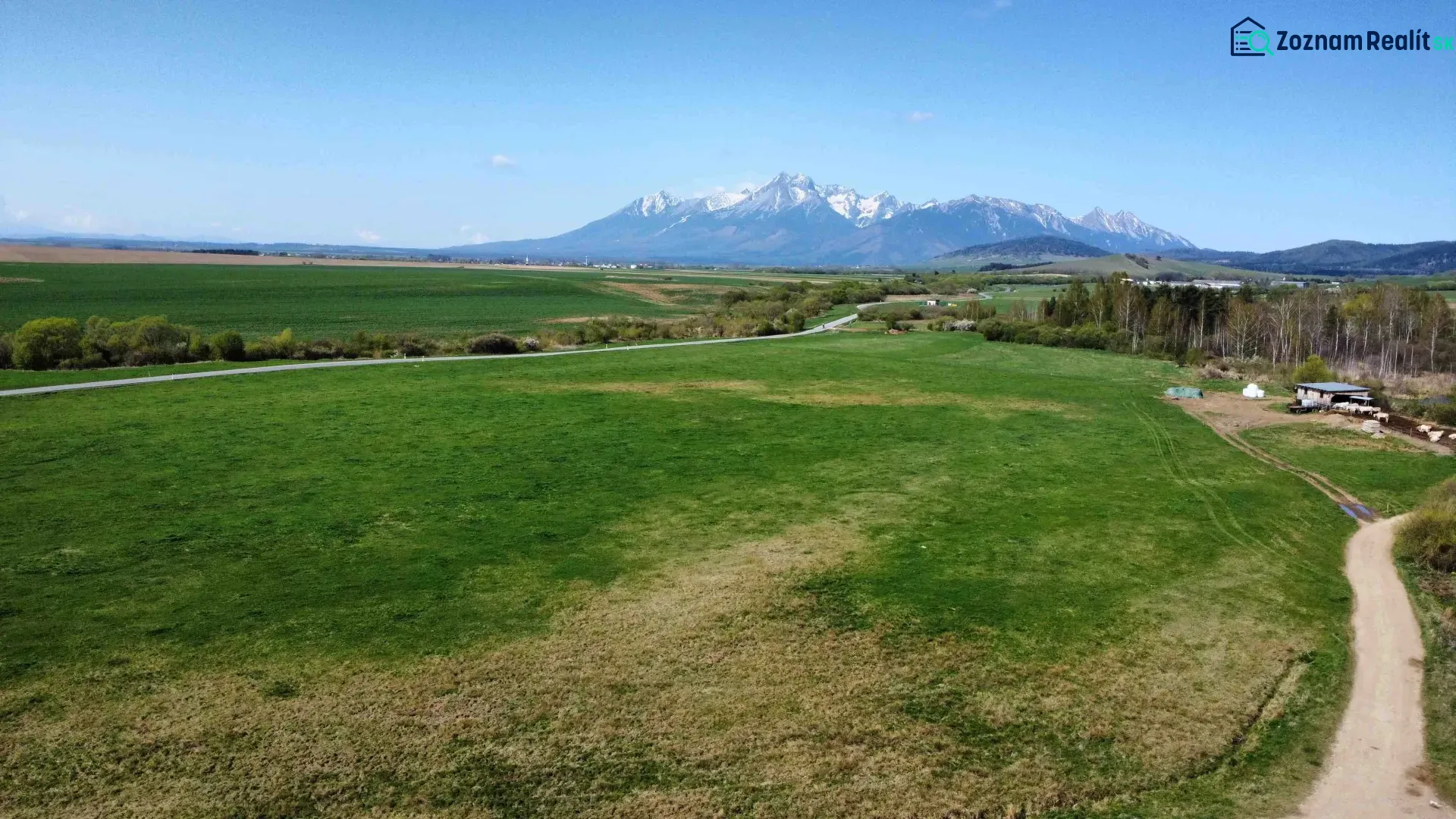 Agricultural and forest land in Podhorany with views of the mountains and green meadows.