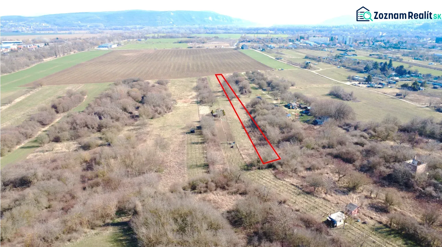 Aerial view of gardens in Štúrovo with a marked plot, surrounded by fields and nature.