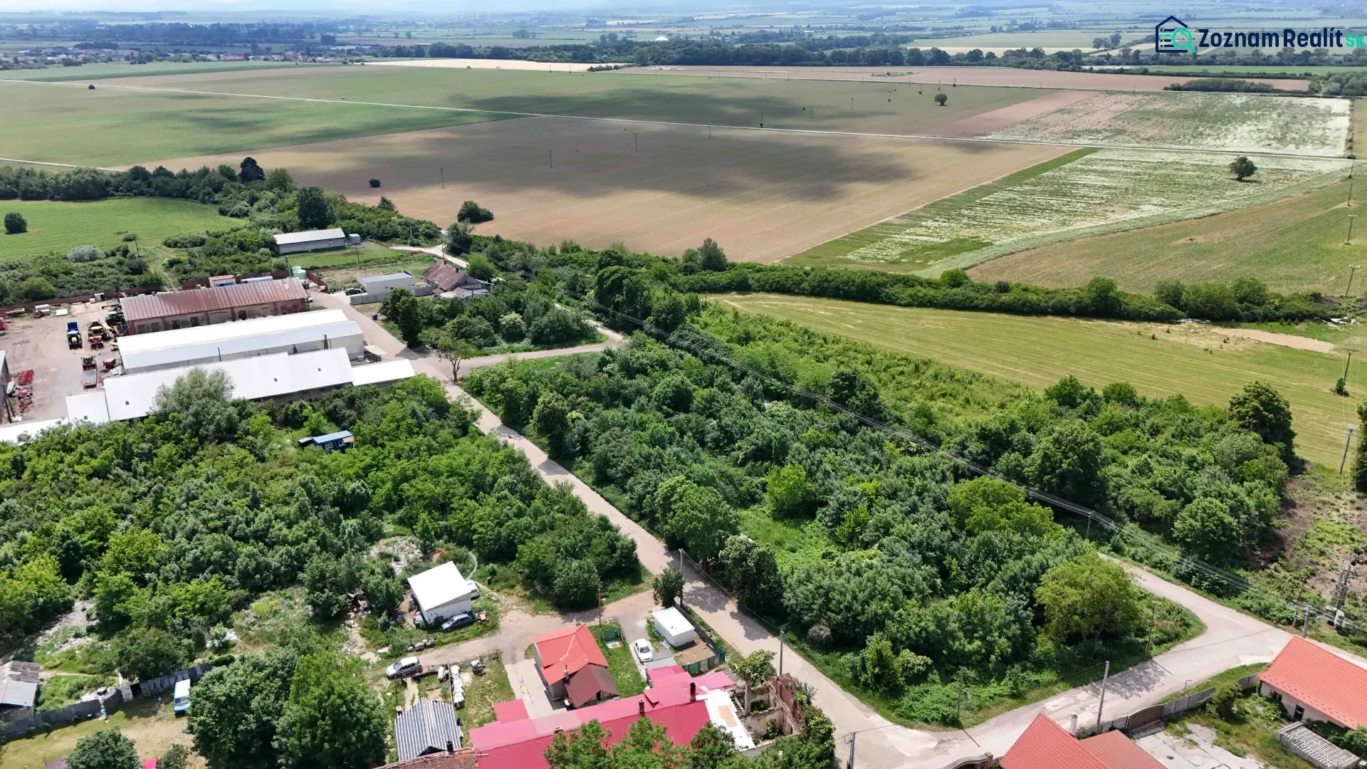 Aerial photograph of residential plots with fields and buildings in Parchovany.