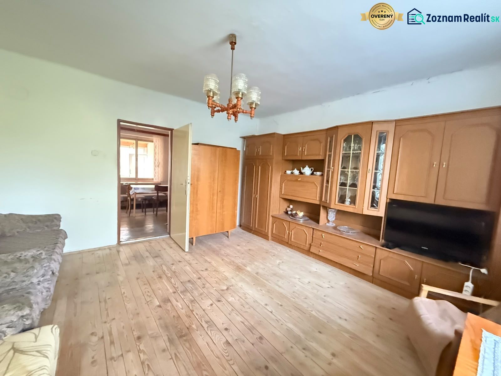 Living room in a family house with a wooden decor floor and a living room wall unit.