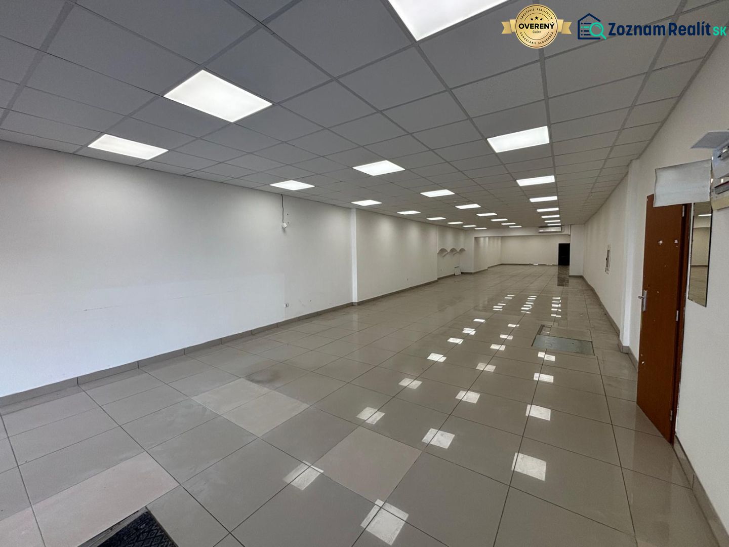 Commercial spaces with light floors and white walls, available for rent.