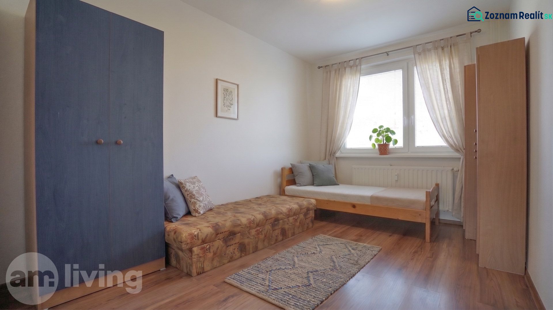 A room in a 3-room apartment with a bed, a wardrobe, and a floor with a wooden decor.