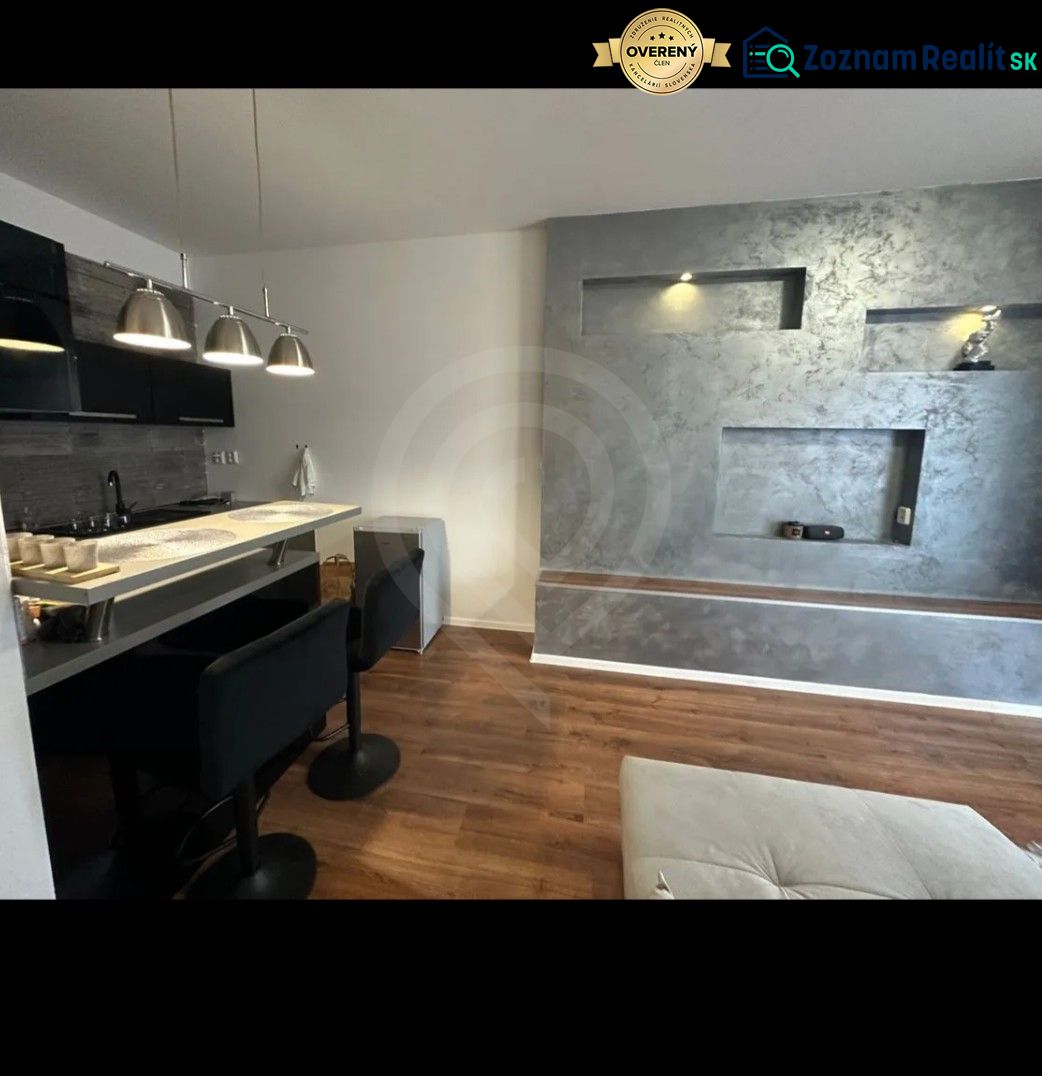 A kitchen corner with a bar counter and a floor with a wood decor in a 2-room apartment.