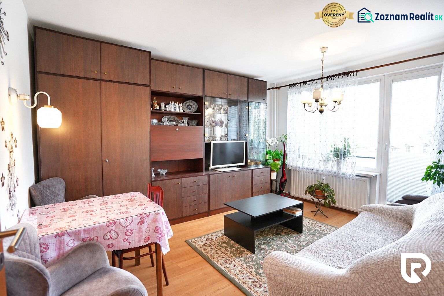 Living room with furniture and wooden decor flooring in a studio apartment.