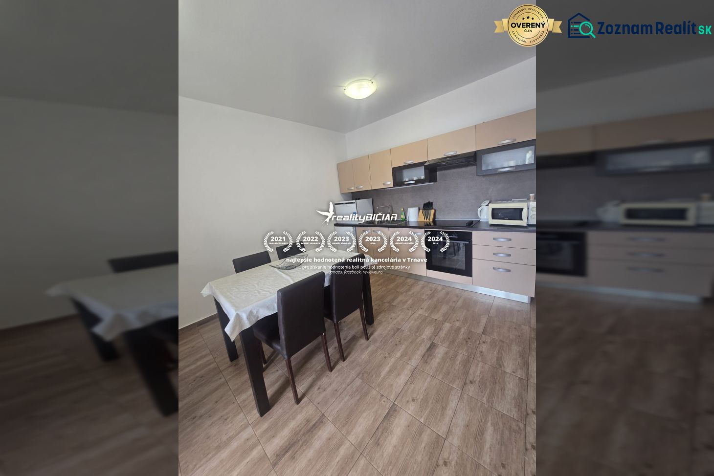 A kitchen with a wooden decor floor and a dining table in a two-room apartment.