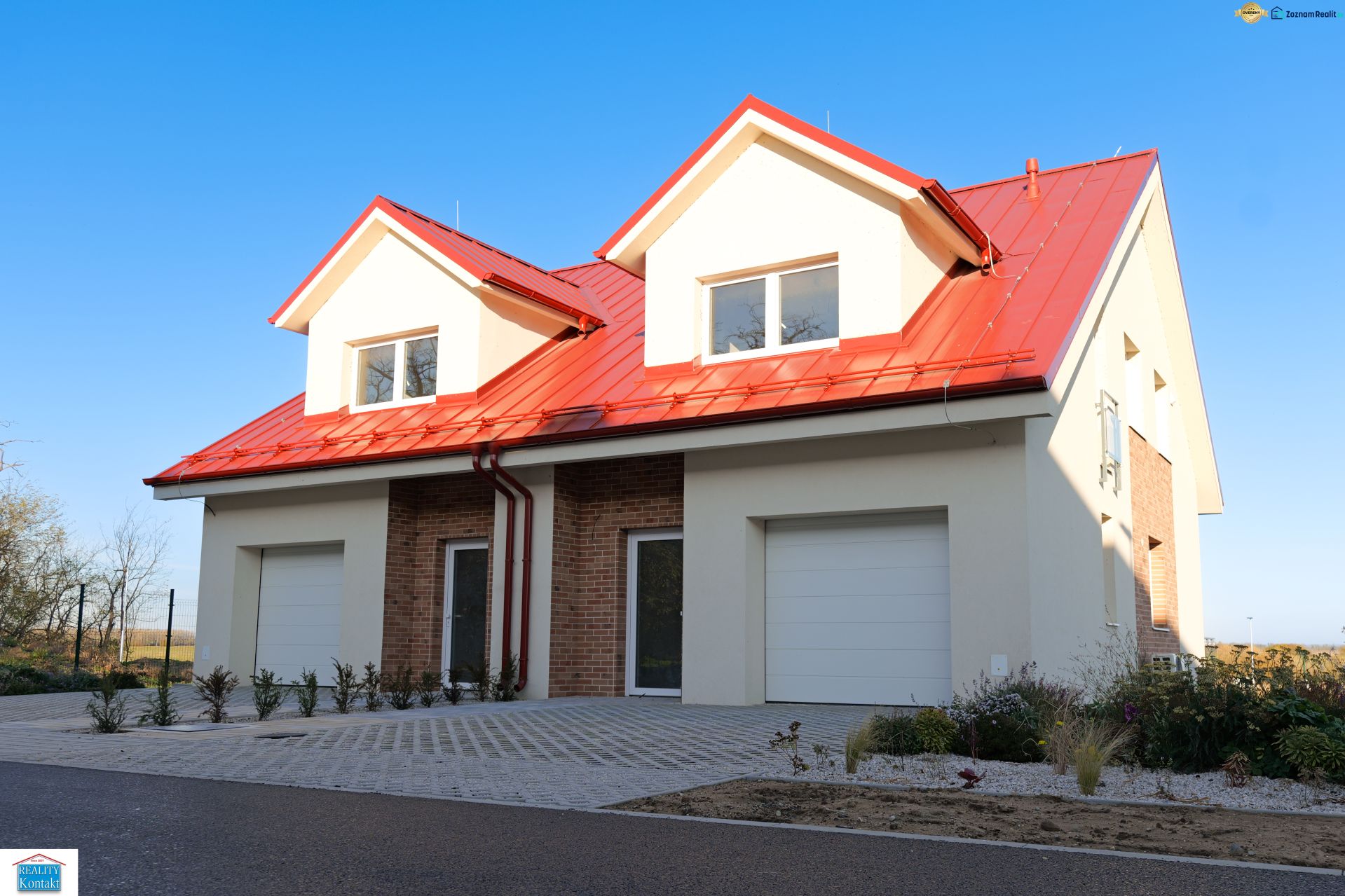 A family house in Andovce with a sloped red roof and white facade.